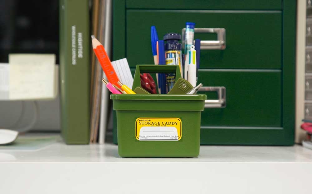 Green Penco Storage Caddy holding pens and scissors on a desk
